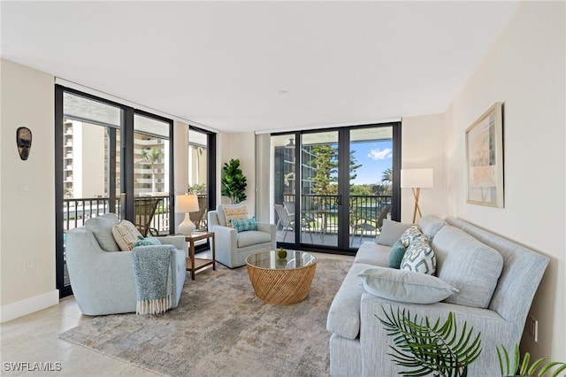 living area with baseboards and floor to ceiling windows