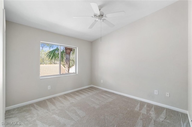 spare room with a ceiling fan, carpet, and baseboards