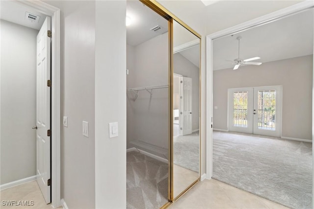 bathroom with lofted ceiling, french doors, visible vents, and ceiling fan