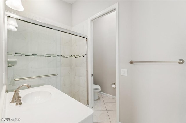 full bathroom featuring a shower stall, a sink, toilet, and tile patterned floors