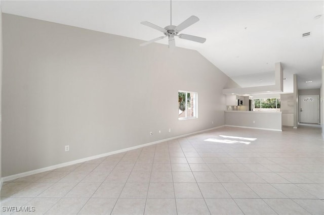 unfurnished living room featuring high vaulted ceiling, light tile patterned flooring, a ceiling fan, and baseboards