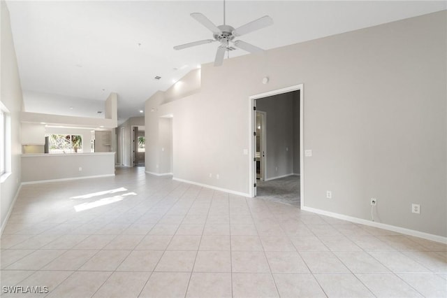 unfurnished living room featuring baseboards, vaulted ceiling, a ceiling fan, and light tile patterned flooring