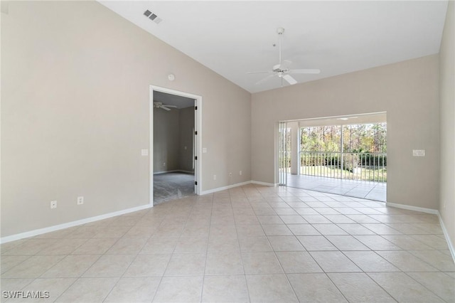 spare room with light tile patterned floors, visible vents, baseboards, ceiling fan, and high vaulted ceiling