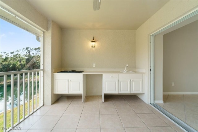 interior space featuring tile patterned flooring and a sink