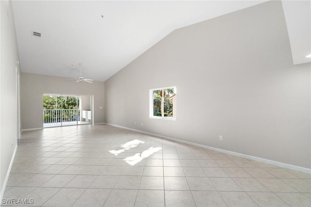 spare room featuring a ceiling fan, a wealth of natural light, light tile patterned flooring, and visible vents