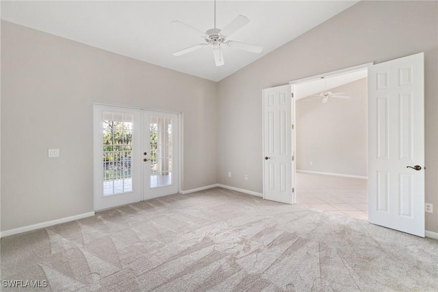 unfurnished room with vaulted ceiling, light colored carpet, a ceiling fan, and french doors