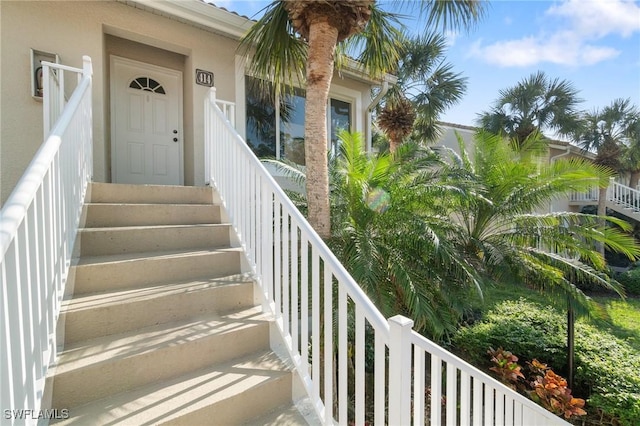 entrance to property with stucco siding