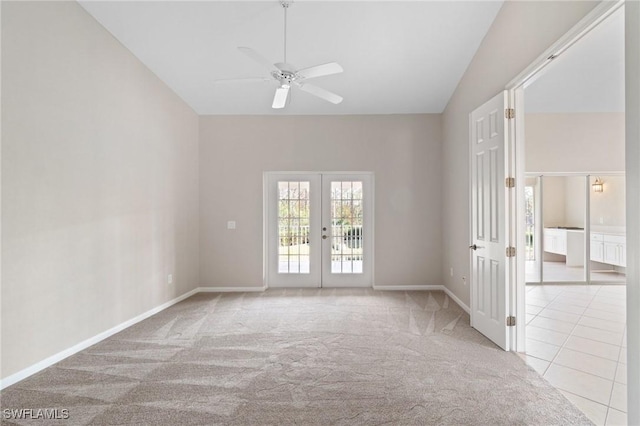 unfurnished room featuring light tile patterned floors, ceiling fan, light colored carpet, baseboards, and french doors