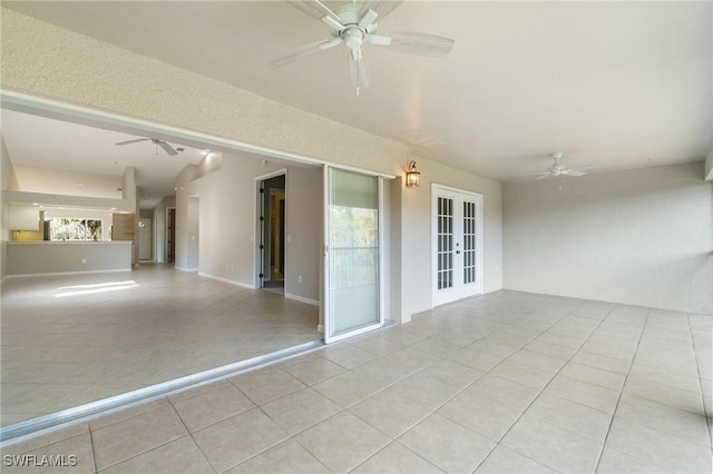 unfurnished room with light tile patterned floors, ceiling fan, french doors, and baseboards