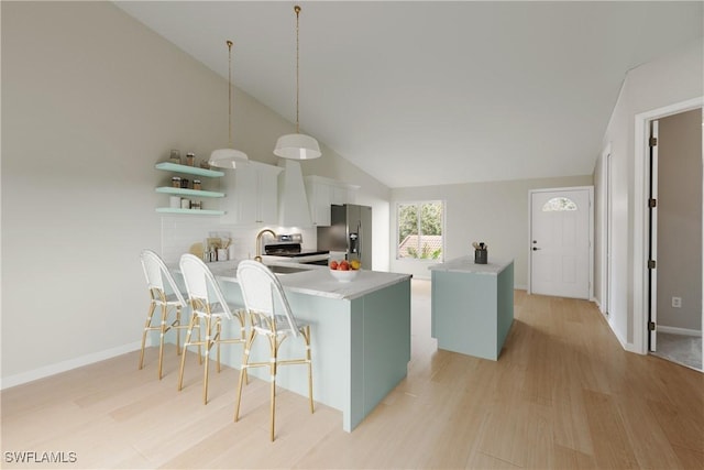 kitchen with a peninsula, white cabinetry, a center island, open shelves, and pendant lighting