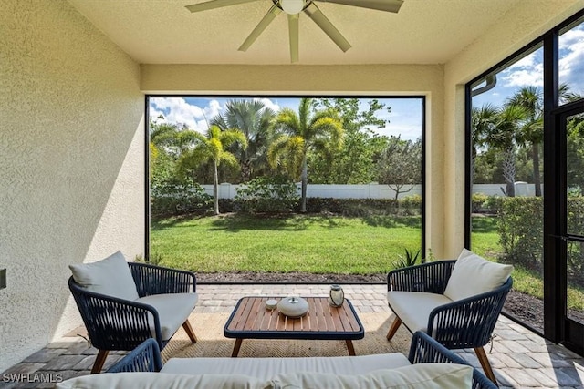 sunroom / solarium featuring ceiling fan