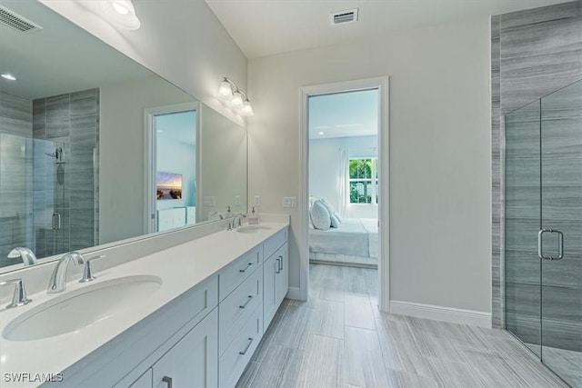 bathroom featuring vanity and an enclosed shower