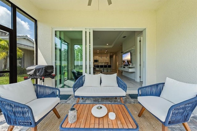 sunroom / solarium featuring ceiling fan