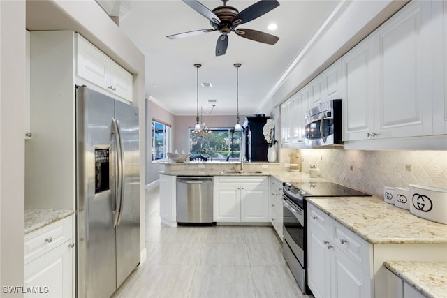 kitchen featuring appliances with stainless steel finishes, white cabinetry, and hanging light fixtures