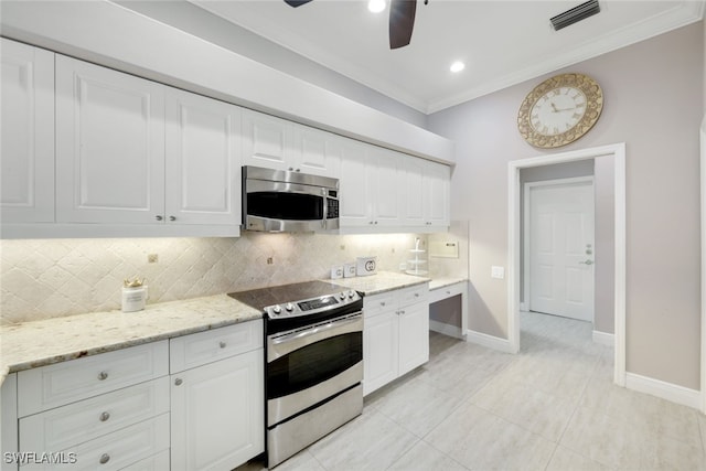 kitchen featuring tasteful backsplash, white cabinets, appliances with stainless steel finishes, ornamental molding, and light stone countertops