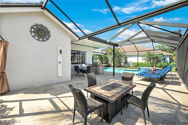 view of patio with glass enclosure, outdoor dining space, exterior kitchen, a pool with connected hot tub, and a fire pit