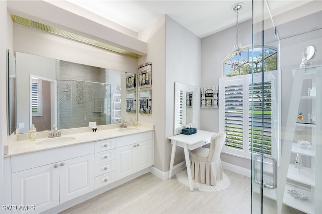 bathroom with double vanity, a stall shower, a sink, and a healthy amount of sunlight