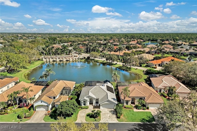 drone / aerial view featuring a residential view and a water view