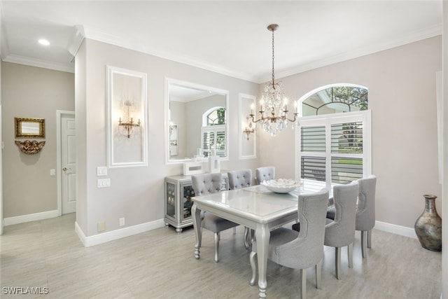 dining area with crown molding, a notable chandelier, and baseboards