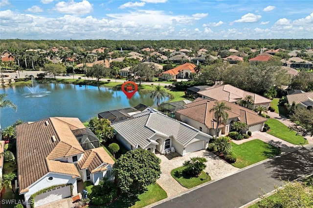 drone / aerial view with a residential view and a water view