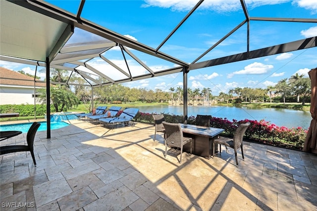 view of patio / terrace featuring a lanai, an outdoor pool, a water view, and outdoor dining space
