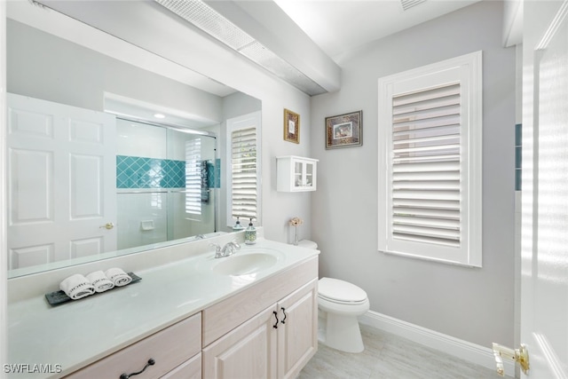 full bathroom with toilet, a stall shower, vanity, baseboards, and tile patterned floors