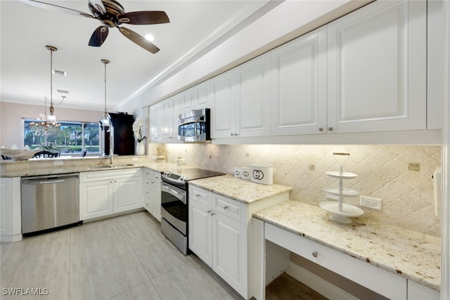 kitchen featuring stainless steel appliances, pendant lighting, white cabinetry, and backsplash