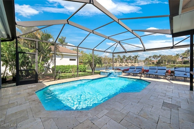 view of pool with a lanai, a pool with connected hot tub, and a patio