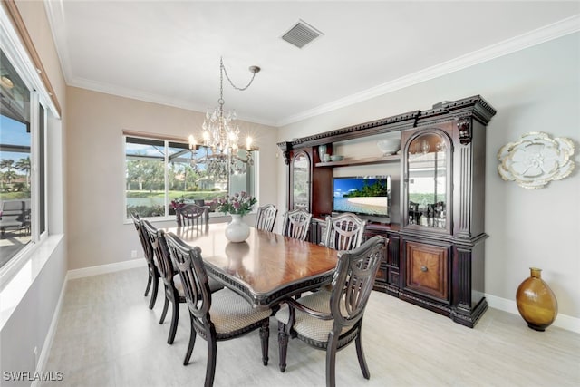 dining room with a chandelier, visible vents, crown molding, and baseboards