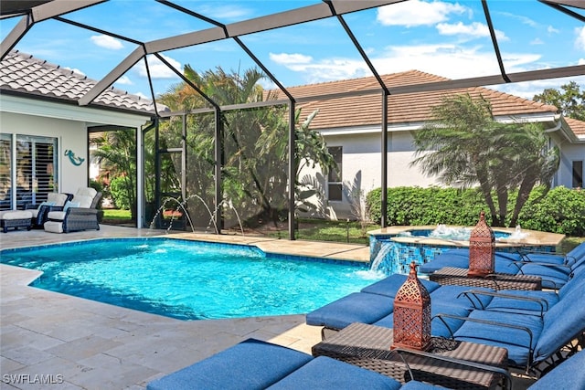 view of pool featuring glass enclosure, a patio, and a pool with connected hot tub