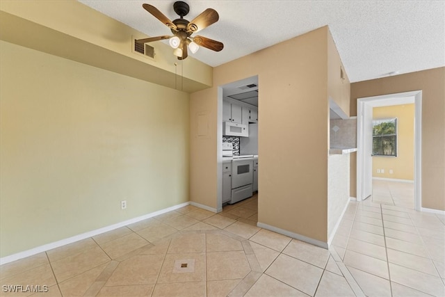 4345 27th Ct SW Unit 204, Naples, FL 34116 - empty room featuring light tile patterned floors, ceiling fan, a textured ceiling, and baseboards