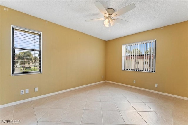 4345 27th Ct SW Unit 204, Naples, FL 34116 - empty room featuring a textured ceiling, ceiling fan, light tile patterned floors, and baseboards
