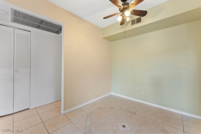 4345 27th Ct SW Unit 204, Naples, FL 34116 - unfurnished bedroom with light tile patterned floors, baseboards, a closet, and a ceiling fan