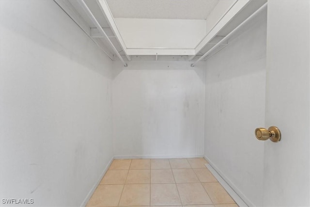 4345 27th Ct SW Unit 204, Naples, FL 34116 - walk in closet with tile patterned flooring