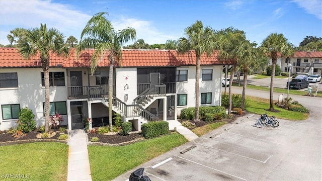 4345 27th Ct SW Unit 204, Naples, FL 34116 - view of property with uncovered parking and stairs