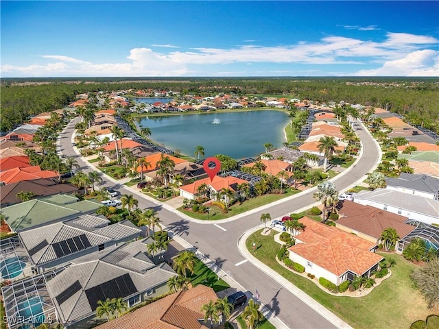 birds eye view of property with a water view and a residential view