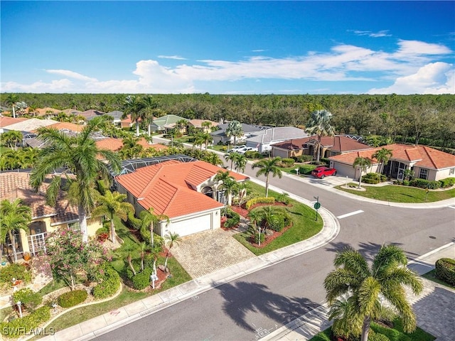 birds eye view of property with a residential view and a wooded view