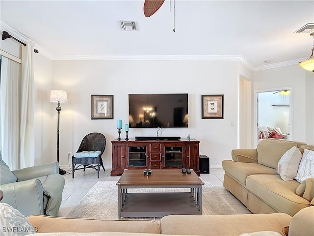 living room with light tile patterned flooring, visible vents, and crown molding