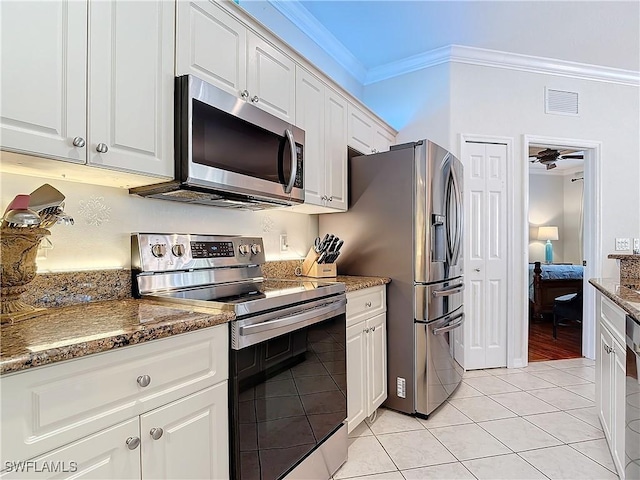 kitchen featuring visible vents, appliances with stainless steel finishes, white cabinets, and crown molding