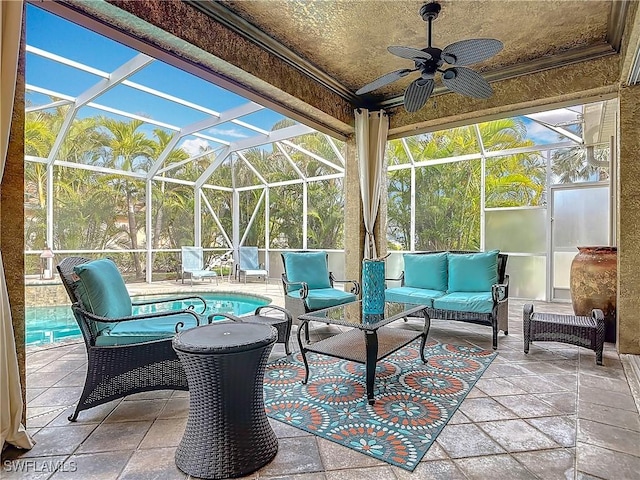 view of patio featuring glass enclosure, outdoor lounge area, and a ceiling fan