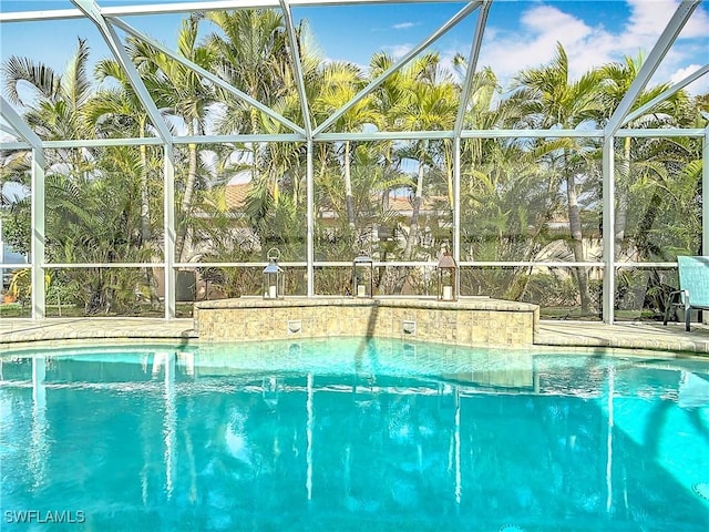 pool with a patio and a lanai