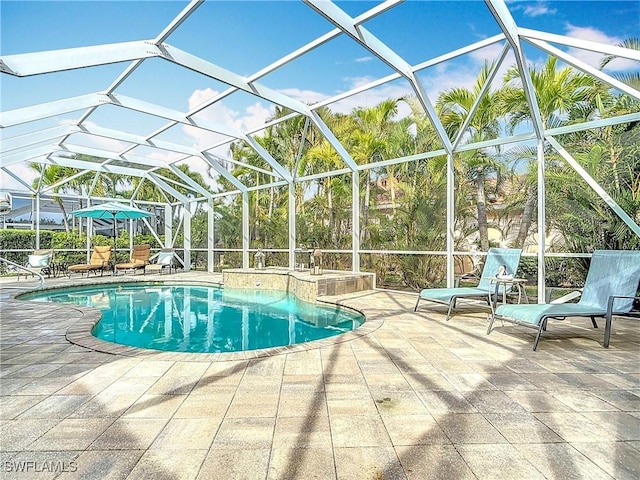 outdoor pool featuring a patio area and glass enclosure