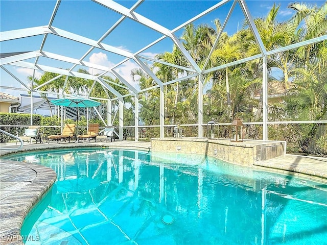 outdoor pool with a lanai and a patio