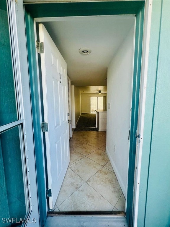 hall featuring light tile patterned floors