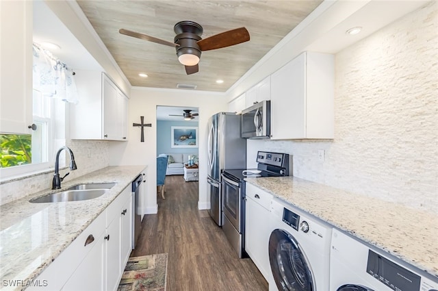 kitchen featuring white cabinetry, sink, stainless steel appliances, and light stone countertops