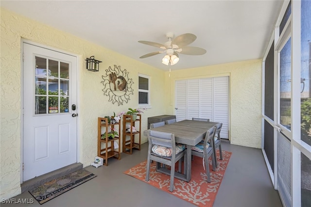 sunroom featuring ceiling fan