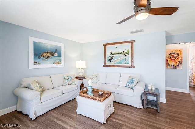 living room featuring dark wood-type flooring and ceiling fan