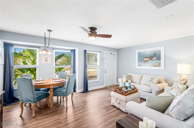 living room featuring ceiling fan and wood-type flooring