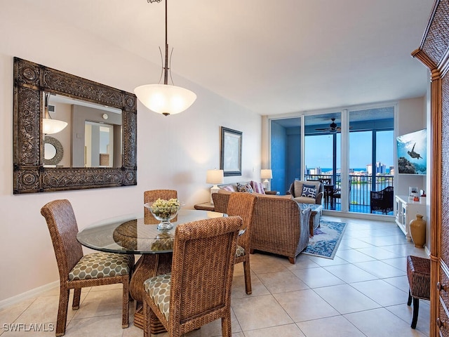 dining room with ceiling fan, expansive windows, a water view, and light tile patterned flooring