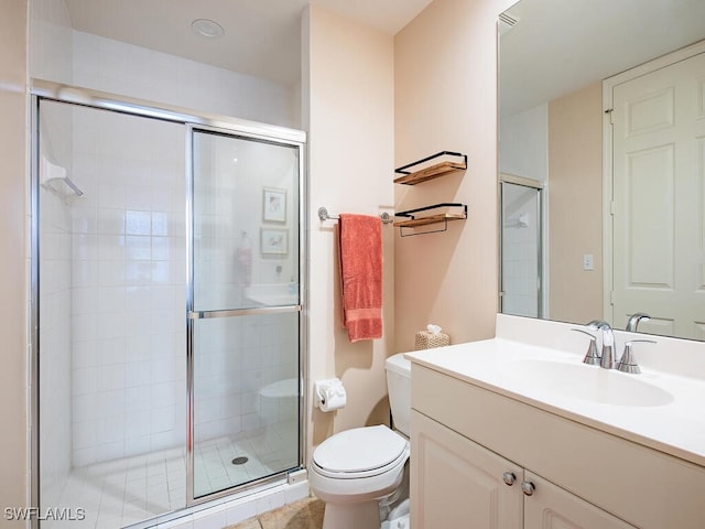 bathroom featuring a shower with door, vanity, and toilet